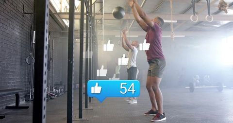 African American Men Performing Wall Balls at Gym with Social Media Engagement