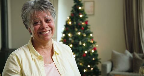 Smiling Woman Celebrating Christmas in Cozy Living Room