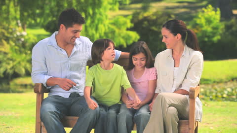 Happy Family Enjoying Time Together in Park on a Sunny Day