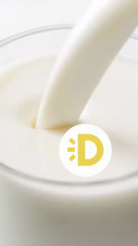 Milk Pouring Stream Filling Glass Vertical High-Key Close-Up Video with D Logo