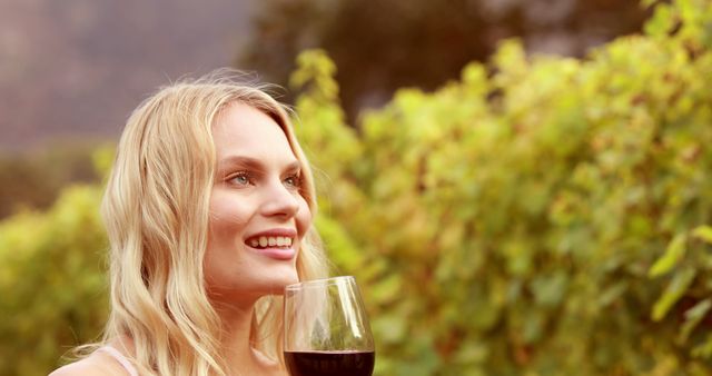 Blonde Woman Enjoying Red Wine in Vibrant Vineyard - Download Free Stock Images Pikwizard.com