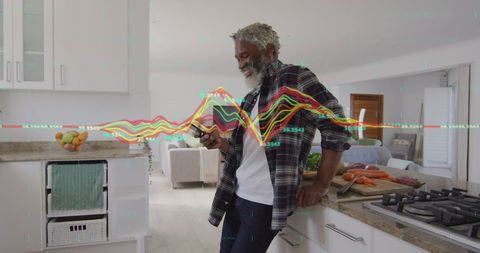 Businessman Analyzing Data on Smartphone in Modern Kitchen