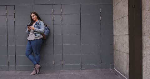 Fashionable Woman with Smartphone Relaxing Against Urban Wall - Download Free Stock Images Pikwizard.com