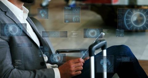 Business traveler using tablet in airport lounge with luggage and futuristic hud interface
