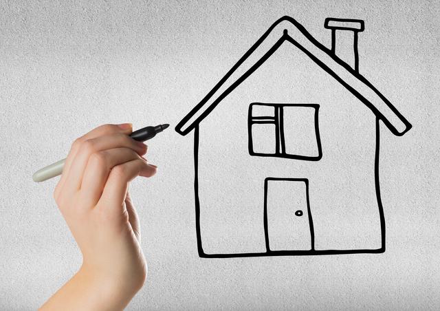 This image shows a hand drawing a simple house with a black marker on a wall. It can be used for real estate promotions, home design concepts, DIY projects, architectural planning, and creative art projects. Ideal for illustrating concepts related to home ownership, construction, and interior design.