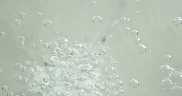 Bubbles rise vigorously in clear water, indicating a strong force or object being submerged. Capturing the dynamic movement of water, this image conveys the energy and turbulence associated with liquid in motion.