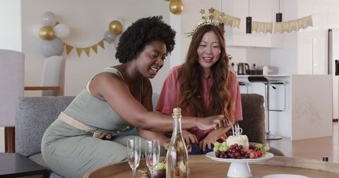Diverse Couple Celebrating Birthday with Cake and Decorations