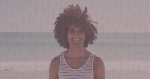 Man Enjoying Calm Beach Vibe in Striped Tank Top at Shoreline