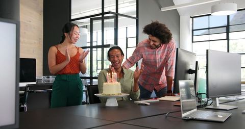 Diverse office team celebrating birthday cheerfully