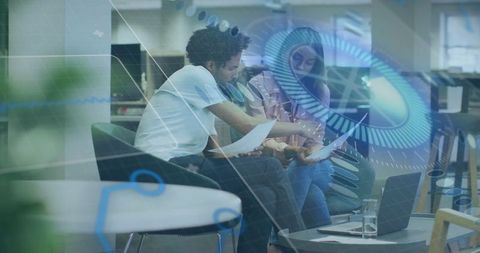 Coworkers Collaborating with Digital Data Overlay in Modern Office Lounge