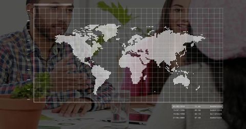 Coworkers discussing global strategy with world map overlay at meeting table