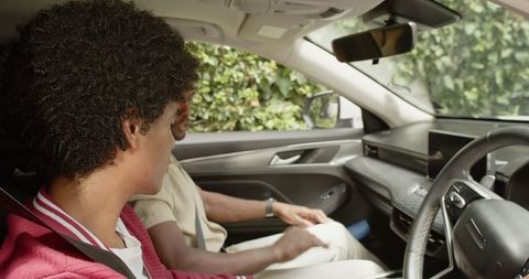 African American Father and Son Bonding Inside Car, Enjoying Road Trip