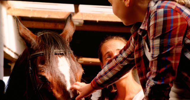 Mother and Daughter Bonding with Horse in Equestrian Stable - Download Free Stock Images Pikwizard.com