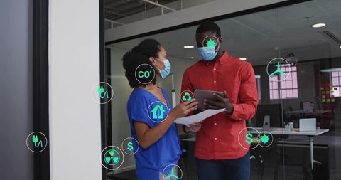 Healthcare professionals reviewing sustainability data on tablet in office with eco icons