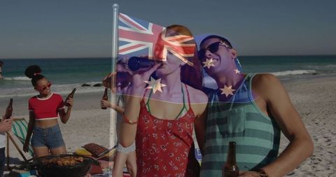 Friends celebrating beach party with australian flag and barbecue