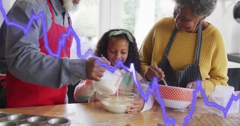 Multigenerational Family Baking Together in Sunlit Kitchen Mixing Batter and Smiling