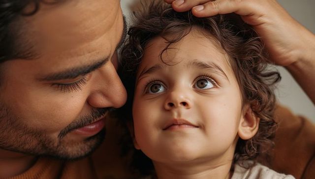 Father caressing child hair closeup tender moment of parental bonding and warmth