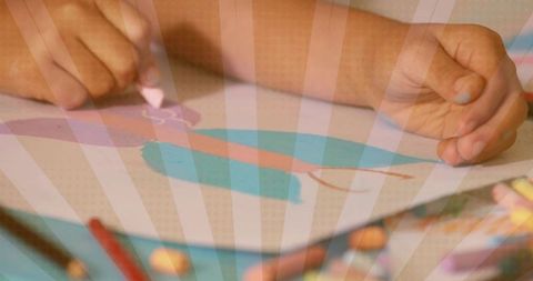 Child drawing with crayons classroom closeup colorful hands creating art