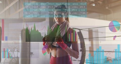 Female boxer training with fitness data overlay, red leggings and tire workout