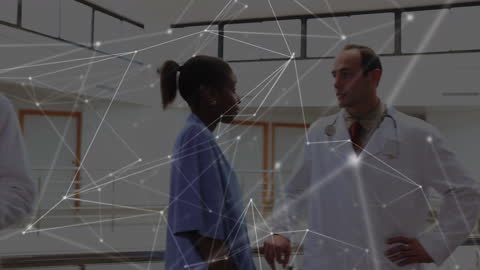 Diverse Doctors Discussing with Digital Data Overlay in Hospital