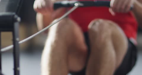Athletic Person Exercising on Rowing Machine in Gym