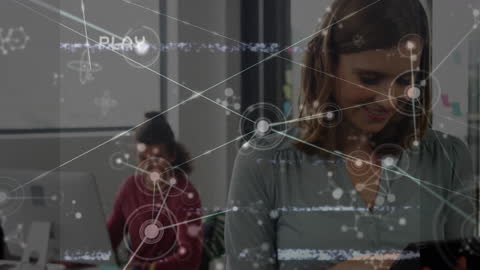 Businesswoman Engaged with Digital Network Visualization in Office