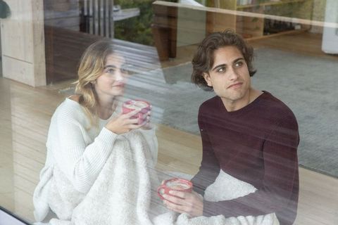 Couple Relaxing at Home with Warm Beverages on Cozy Morning