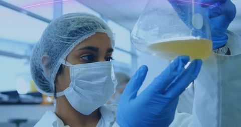 Female Scientist Analyzing Liquid in Erlenmeyer Flask in Laboratory