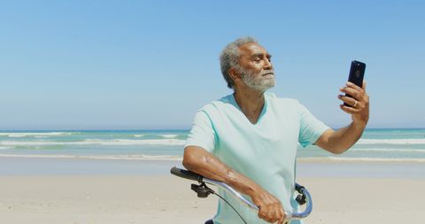 Senior Man with Bicycle Taking Selfie on Sunny Beach - Download Free Stock Images Pikwizard.com