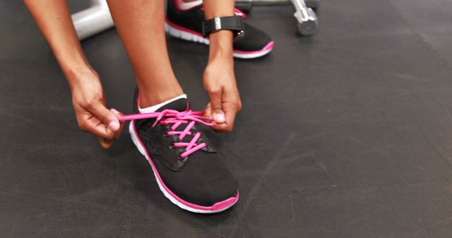 Fit woman tying his shoes in crossfit