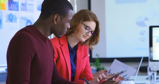 African American Man and Redheaded Woman Collaborating on Work Project - Download Free Stock Images Pikwizard.com