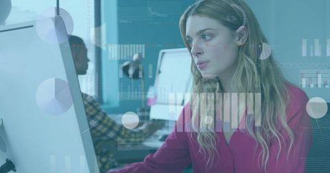 Focused Businesswoman Analyzing Data on a Computer in Modern Office