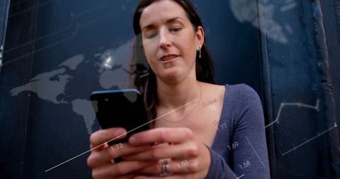 Woman Analyzing Data on Smartphone Against Digital Graph Overlays