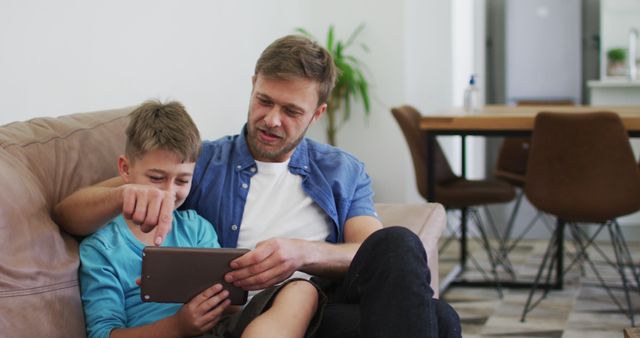 Father and Son Bonding While Using Digital Tablet at Home - Download Free Stock Images Pikwizard.com