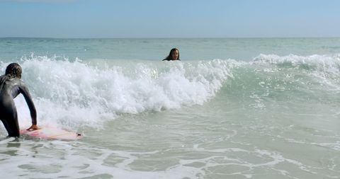 Young surfers riding ocean waves in thrilling adventure - Download Free Stock Images Pikwizard.com