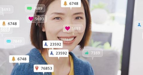 Smiling chinese woman on sofa with social media engagement overlays, cozy living room