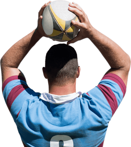 Rugby player holding ball overhead on transparent background