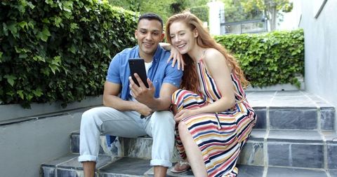 Happy couple celebrate new beginnings phone video call