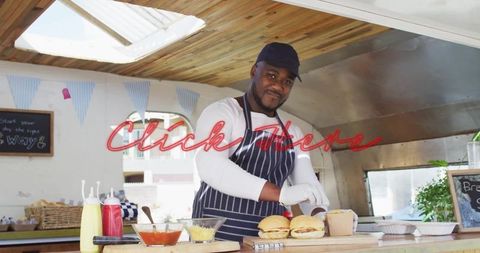 Smiling Cook Preparing Gourmet Burgers in Food Truck Kitchen