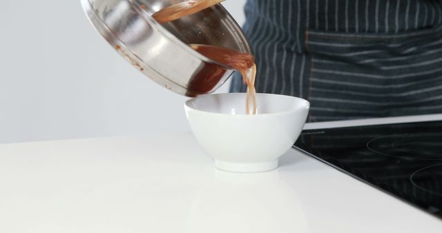 Chef Pouring Freshly Made Sauce from Pot into Bowl - Download Free Stock Images Pikwizard.com