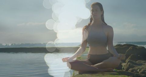 Serene Woman Practicing Yoga Meditation at Sunset by Ocean