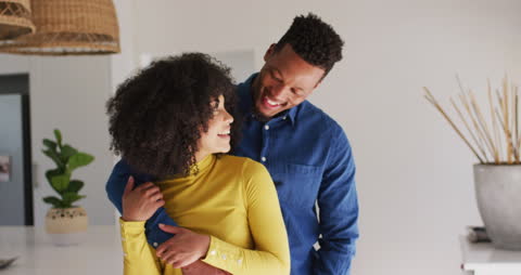 Loving Couple Embracing at Home in Bright Modern Space