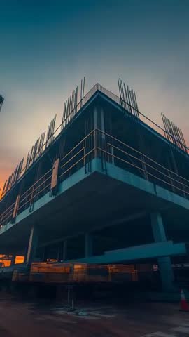 Low-Angle Construction Video at Dusk Showing Exposed Rebar and Concrete Slab Corner