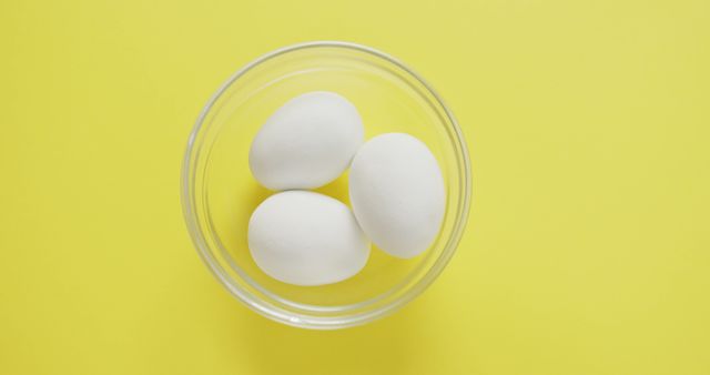 Three White Eggs in Glass Bowl on Bright Yellow Background - Download Free Stock Images Pikwizard.com