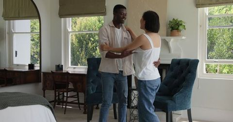 Happy Couple Embracing in Bright Stylish Living Room
