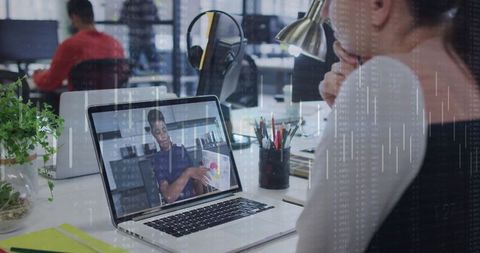 Businesswoman Joining Virtual Meeting on Laptop in Modern Office