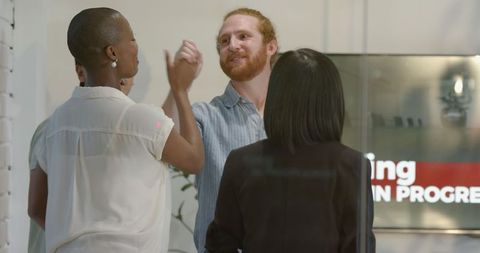 Diverse Team Brainstorming Business Ideas in Modern Office