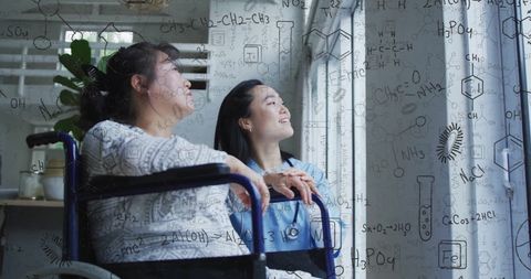 Asian Nurse with Wheelchair-Bound Patient Overlaid with Scientific Data - Download Free Stock Images Pikwizard.com
