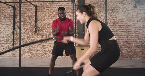 Intense Battle Rope Training with Fitness Coach in Industrial Gym