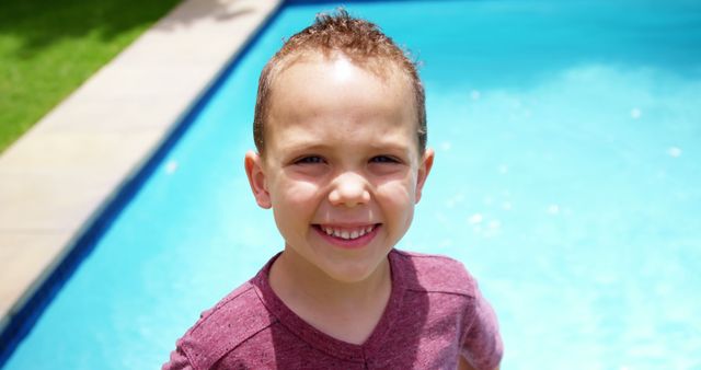 A young boy is having a great time near a swimming pool on a bright and sunny day. His cheerful smile conveys joy and happiness, perfect for promoting summer activities, family vacations, outdoor fun, and positive childhood experiences. Ideal for advertisements, blog posts, and social media campaigns focused on summer leisure and family bonding.